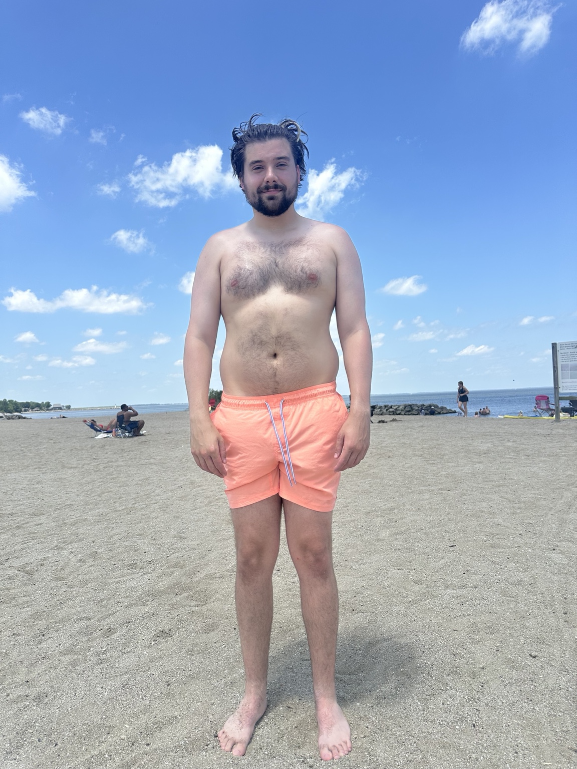 Before weight-loss photo of Greg standing on a beach