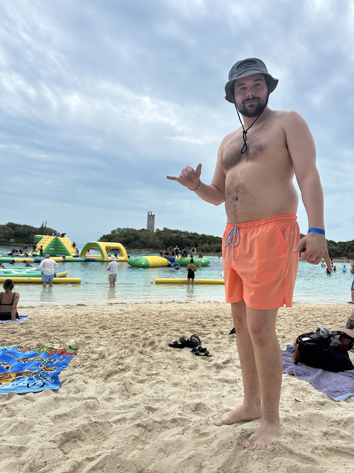 Before weight-loss photo of Greg standing on a beach from the side