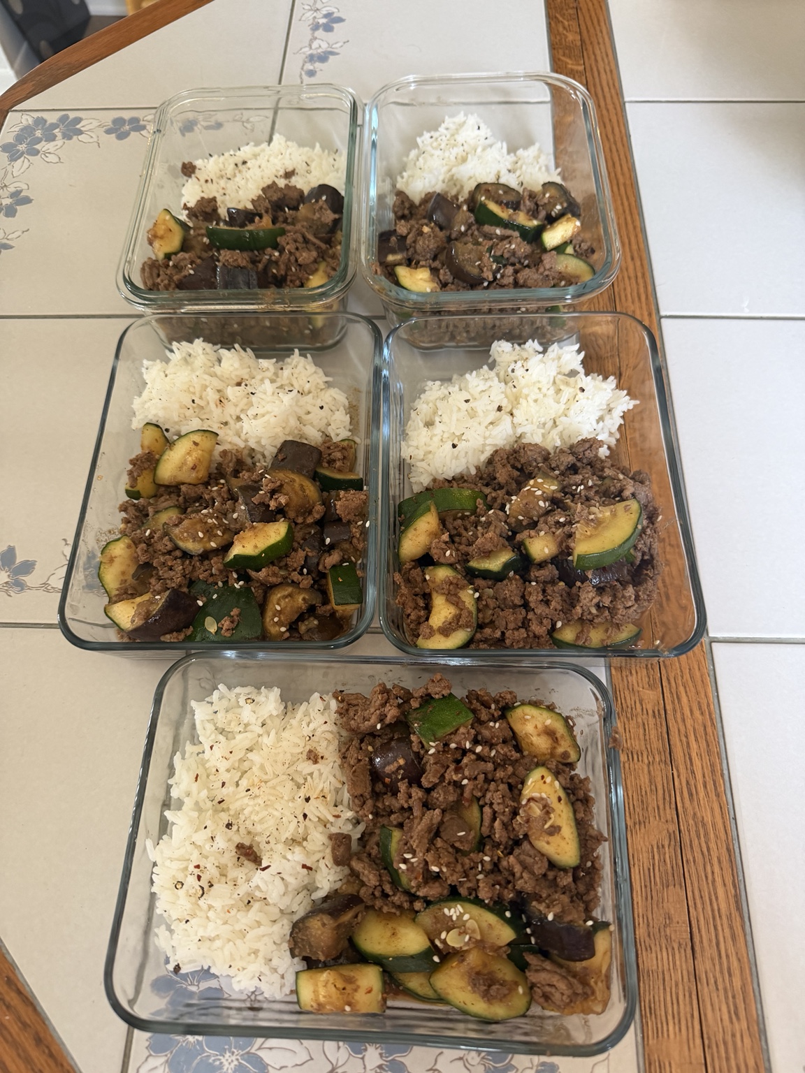 Meal-prep bowls with rice, zucchini, eggplant, and ground beef