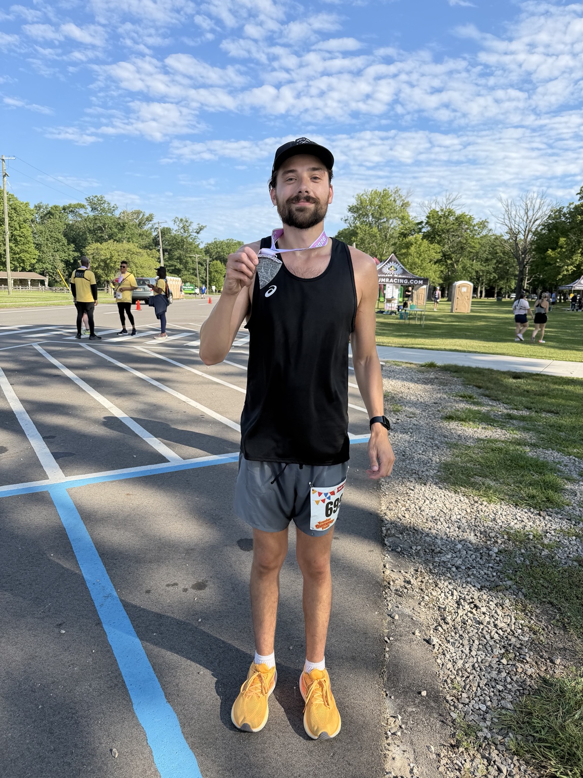 Greg holding a medal after another race